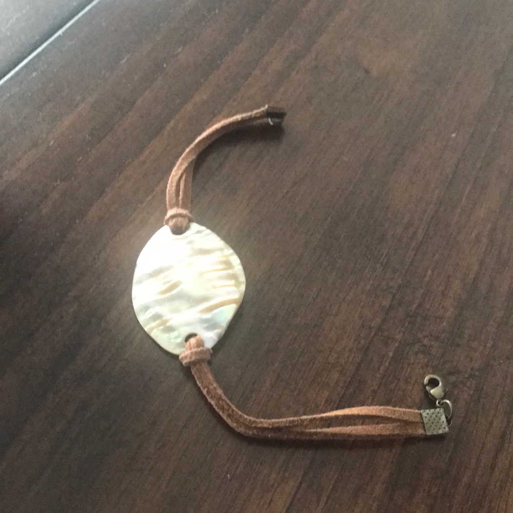 Shell bracelet with suede cords.